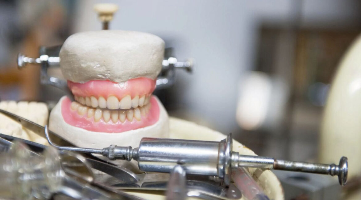 A collection of antique dental tools and implements, set against a dark background, evoking the early practices and historical evolution of dentistry. The worn appearance of the instruments highlights the journey from rudimentary care to modern advancements.